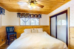 a bedroom with a bed and a ceiling fan at Idyllic Cabin in the Woods: Cozy Crestline Retreat in Arrowhead Highlands