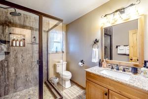 a bathroom with a shower and a toilet and a sink at Idyllic Cabin in the Woods: Cozy Crestline Retreat in Arrowhead Highlands +17 photos
