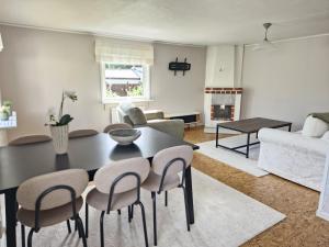 a living room with a black table and chairs at Havsnära stuga in Varberg