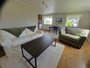 a living room with a couch and a table at Havsnära stuga in Varberg