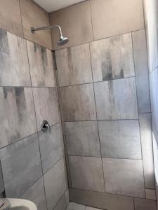 a bathroom with a shower with a glass door at The Gardens view lodge in Bushbuckridge +6 photos