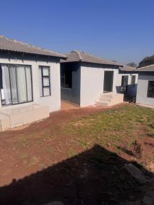 an empty yard in front of a house at The Gardens view lodge in Bushbuckridge