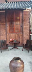 a room with a table and two benches and a vase at VNJ Capsule 159 in Hoi An