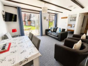 a living room with a table and chairs at Cornwall Cosy Bungalow in Hayle