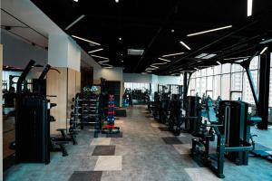 a gym with a row of treadmills and machines at May Seven Hotel and Suites in Ulaanbaatar