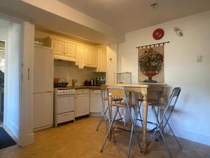 a kitchen with a table and chairs in a room at Van Guesthouse in Vancouver