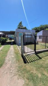 a fence in front of a house at Monoambiente La Falda in La Falda