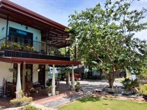 a building with a tree in front of it at Ella Nature valley homestay in Ella