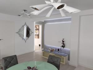 a dining room with a ceiling fan and a table at LEMIGA SUiTE VALENCIA in Valencia +6 photos