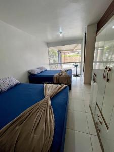 a bedroom with two beds and a door to a balcony at 11-Casa espaçosa com garagem e Wi-Fi in São Leopoldo +18 photos
