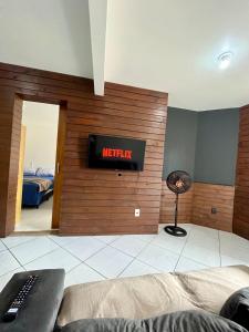 a living room with a sign that reads mercury at 11-Casa espaçosa com garagem e Wi-Fi in São Leopoldo