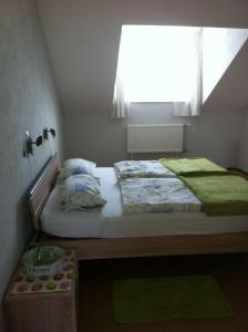 a small bedroom with a bed and a window at Landgasthof Hegau in Dunaszekcső