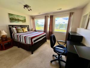 a bedroom with a bed and a desk and a window at Imperial Ranchettes GuestSuite in Lone Butte