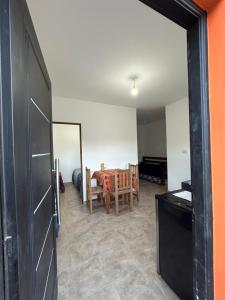 a dining room with a table and a mirror at Hospedaje ESMERALDA in Volcán