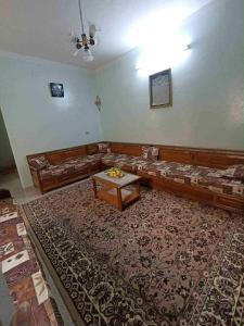 a living room with a couch and a table at Dar arbi in Kelibia
