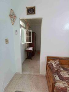 a room with a bedroom with a bed and a window at Dar arbi in Kelibia