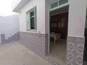 a building with a window and a table in front of it at Dar arbi in Kelibia