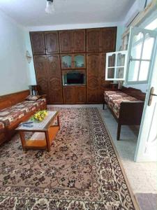 a living room with a couch and a coffee table at Dar arbi in Kelibia