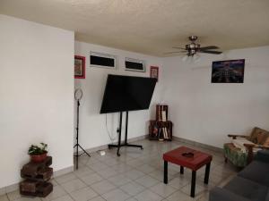 a living room with a flat screen tv on the wall at Casa Lago de Luz in San Juan Cosalá