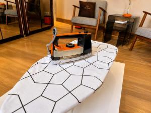 a machine sitting on a table in a living room at Chez Claude - Retro Chic Suite in Charleroi