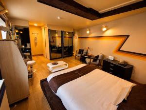 a hotel room with a large bed and a bathroom at Chez Claude - Retro Chic Suite in Charleroi