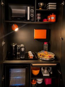 a kitchen with a counter top with a microwave at Chez Claude - Retro Chic Suite in Charleroi