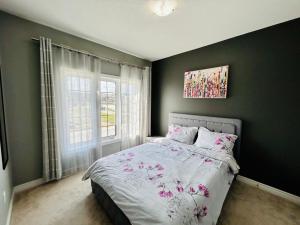 a bedroom with a bed and a window at The Grand Maple Residence in Brampton
