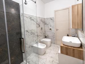 a bathroom with a toilet and a sink and a shower at Case Vacanze Porto Vecchio in Lampedusa