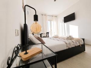 a bedroom with a bed and a glass table at Case Vacanze Porto Vecchio in Lampedusa +40 photos