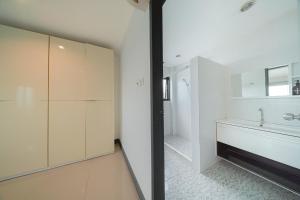 a white bathroom with a tub and a sink at Gao Lighthouse Phala Beach in Ban Phala +30 photos