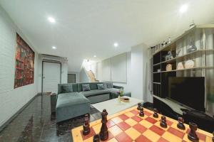 a living room with a couch and a television at Gao Lighthouse Phala Beach in Ban Phala