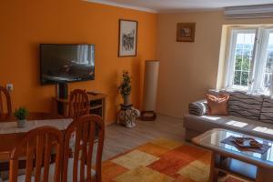 a living room with a couch and a table at Kovaci Garden House in Sarajevo