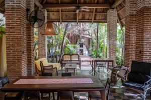 a patio with tables and chairs in a brick building at Casa De Columnas in Cartagena de Indias