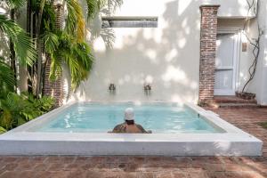 a man in a swimming pool in a house at Casa De Columnas in Cartagena de Indias