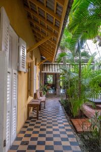 a porch of a house with a checkered floor at Casa De Columnas in Cartagena de Indias