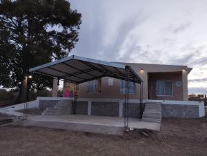 a building with a black canopy in front of it at Villa Sol in San Ignacio