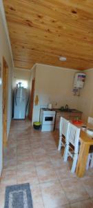 a kitchen with a wooden ceiling and a table and chairs at Villa Sol in San Ignacio