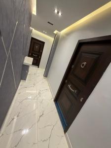 a hallway with a door and a marble floor at Happy apartment 3 in Cairo