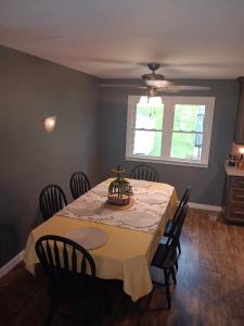 a dining room with a table with chairs and a window at Dubuque's Hidden Gem! in Dubuque