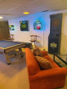 a ping pong table and a couch in a room with a ping pong at Dubuque's Hidden Gem! in Dubuque