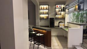 a kitchen with a bar with stools in it at Hotel El Galeón in Paracas