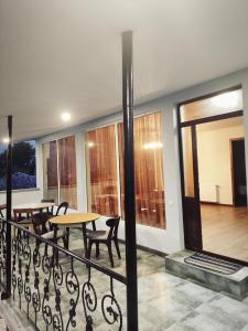 a balcony with a table and chairs and a table at NIISS house in Akhaltsikhe