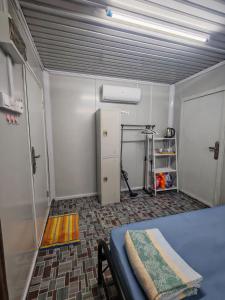 a room with a garage with a door and a treadmill at STUDIO HOMESTAY Arjuna in Pantai Remis