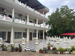a building with a black and white checkered floor at Neem Tree Farm Stay in Ujjain
