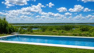 a swimming pool with a view of a river at Destinar Tiny House in San Pedro