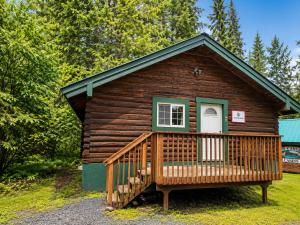 a log cabin with a porch and a door at Box Canyon Cabins in Seward +17 photos