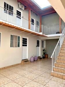 a building with a staircase and a balcony at Estadia Perfeita com AC, Apto a minutos do Aeroporto Gru in Guarulhos