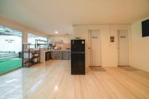 a kitchen with a black refrigerator in a room at GAO Phala Beachfront Hostel in Ban Phala +40 photos