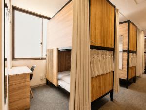 a room with a bunk bed with a sink and a window at Namba Guesthouse HIVE in Osaka +29 photos