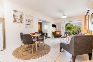 a living room with a table and chairs at Lagoons Resort Apartment 63 in Agnes Water